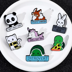 Detail of seven cartoon animal enamel pins including fox and panda on a white plate