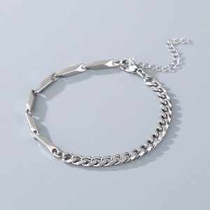 Detail of silver stainless steel Cuban link bracelet with bar segments and extender