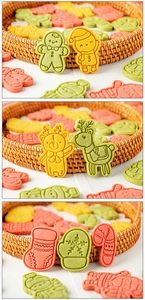 Close-up of colorful Christmas cookies in gingerbread man, reindeer, and stocking shapes