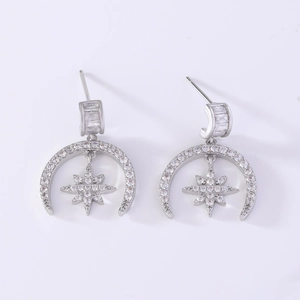 Detail of silver moon and star stud earrings with shimmering cubic zirconia stones