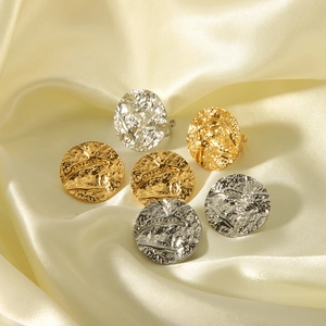 Textured hammered metal round stud earrings in gold and silver finish on silk