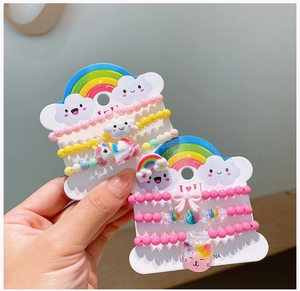Close-up of children's acrylic beaded bracelets with unicorn and rainbow charms