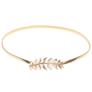Detailed close-up of a gold metal leaf buckle on a flexible elastic spring waist belt