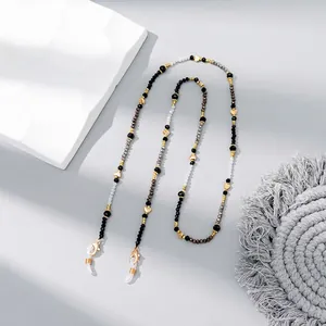 Detail of beaded eyewear chain with golden hearts and lobster clasps for women