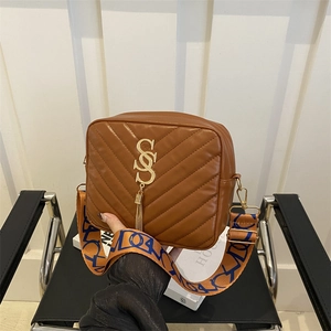 Brown quilted camera bag with wide patterned strap and gold logo detail