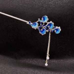 Detailed view of blue enamel cloud hairpin with rhinestone accents and pearl tassels