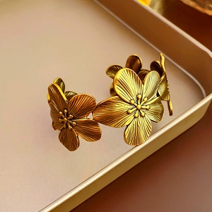Detailed macro view of vintage bronze gold flower bracelet with textured petals