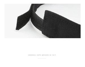 Detail of adjustable Velcro strap and twill fabric texture on the black sun visor cap