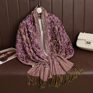 Detailed view of luxury purple cashmere shawl with paisley patterns and elegant tassels