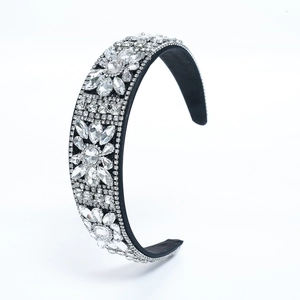 Close-up of black velvet headband featuring sparkling crystal and diamond flower detailing
