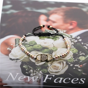 Adjustable black rope bracelet with mixed tricolor copper beads and a gold heart locket