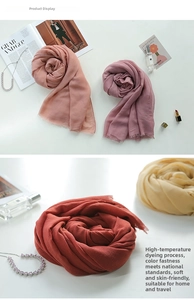 Detail showing the soft texture and natural raw edges of colored linen blend scarves