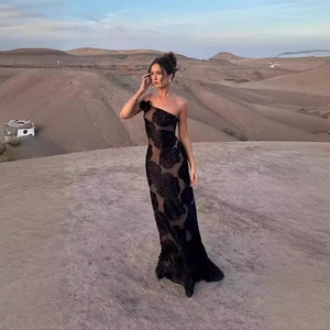 Elegant one-shoulder black evening gown with 3D rose flocking and mesh in a desert setting
