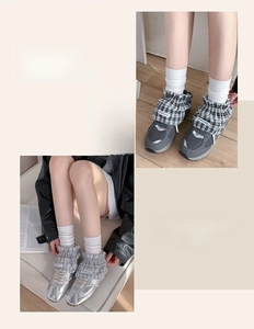 Detail of plaid ruffle ankle cuffs styled with metallic sneakers and mesh running shoes
