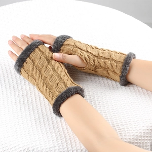 Detailed close-up of cable knit fingerless gloves with plush dark grey faux fur trim