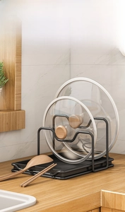 Kitchen counter storage rack with vertical slots for pot lids and wave design tray