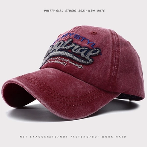 Detail of burgundy washed cotton baseball cap featuring vintage 3D textured embroidery