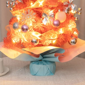 Detail of 55cm mini orange-pink Christmas tree with warm LED lights and silver ornaments