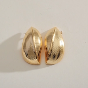 Minimalist golden leaf-shaped geometric earrings with a refined metallic texture