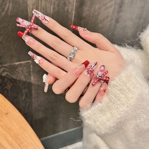 Handmade red and white plaid press-on nails with 3D bows, cherry patterns, and pearls