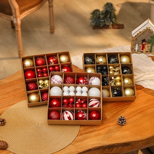 Set of assorted red gold and white Christmas balls in organized gift box packaging
