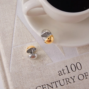 Polished hollow half-sphere hoop earrings in gold and silver finish on white background