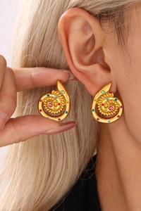 Close-up of 18k gold plated spiral earrings with vibrant multicolor crystal settings