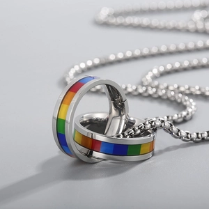 Close-up of hip hop stainless steel necklace with interlocking rainbow double ring pendants