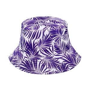 Detailed view of white bucket hat with vibrant purple tropical palm leaf pattern