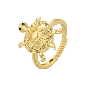 Detailed close-up of a golden turtle ring featuring a shell set with sparkling zircons