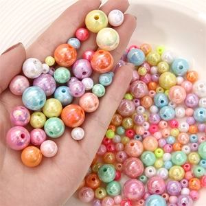 Close-up of colorful pearlescent acrylic beads for DIY jewelry making in various sizes