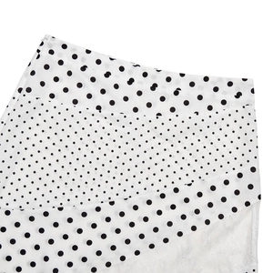 Detail of white polka dot skirt with invisible zipper and lightweight chiffon fabric
