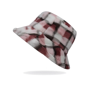 Close-up of pink and black plaid faux fur bucket hat with soft plush texture