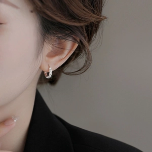 Elegant S925 sterling silver daisy hoop earrings with beaded texture on model