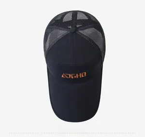 Detailed top view of a black mesh baseball cap with orange embroidery and long visor