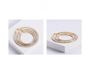Macro detail of gold plated square hoop earrings with sparkling pave zircon settings
