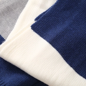 Close-up of winter knit set fabric texture with navy blue and grey color blocking details