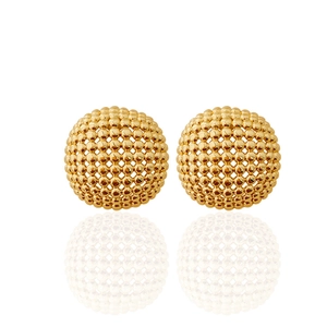 Detail view of golden spherical stud earrings with textured mesh woven pattern and reflection