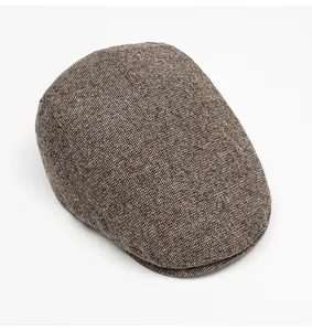 Top down view of a winter baker boy cap featuring a brown tweed textured knit pattern