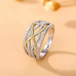 Macro shot of wide infinity ring with two-tone gold and silver pavé-set crystals