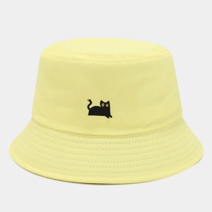 Close-up of cute black cat embroidery on yellow cotton bucket hat with fine stitching