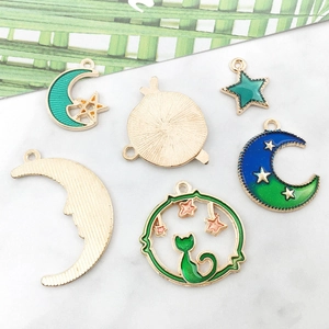 Macro view of gold moon and star enamel alloy charms on a marble background