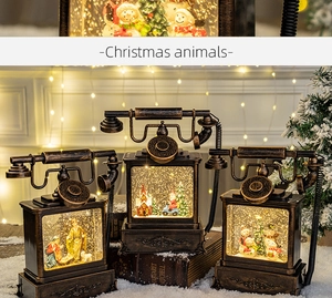 Detail of vintage Christmas telephone lanterns with bronze finish and LED snow scene