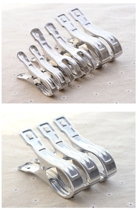 Heavy-duty stainless steel windproof clips for quilts and laundry on fabric background