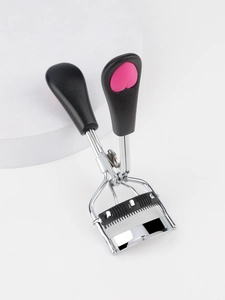Detail of eyelash curler with built-in comb and pink heart handle on a display stand