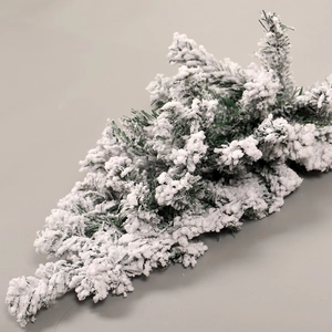 Flocced artificial Christmas teardrop tree with heavy snow dusting and green needles