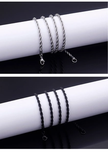 Detailed close-up of twisted rope chain necklaces in silver and black metal finishes