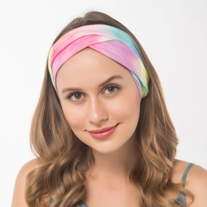 Close-up of tie-dye twist yoga headband with pink and blue gradient on a female model