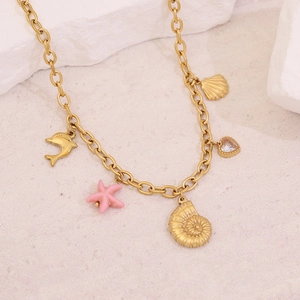 Detailed shot of gold necklace with dolphin, starfish and shell ocean charms
