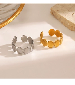 Detail view of gold and silver oval-link open rings displayed on a minimalist background